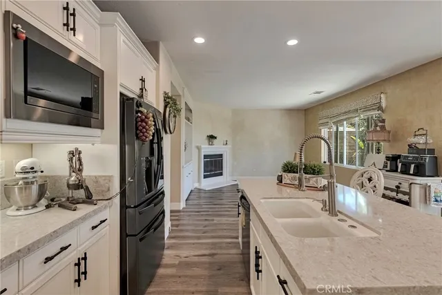 a kitchen with stainless steel appliances granite countertop a refrigerator sink and cabinets