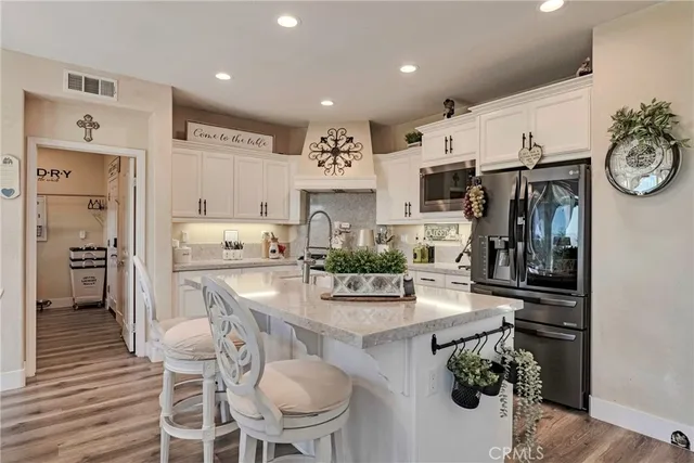 a dining room with furniture a chandelier and wooden floor