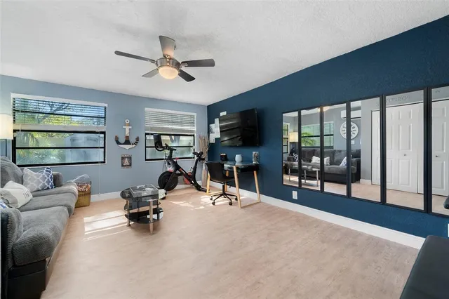 a view of a livingroom with furniture and a flat screen tv