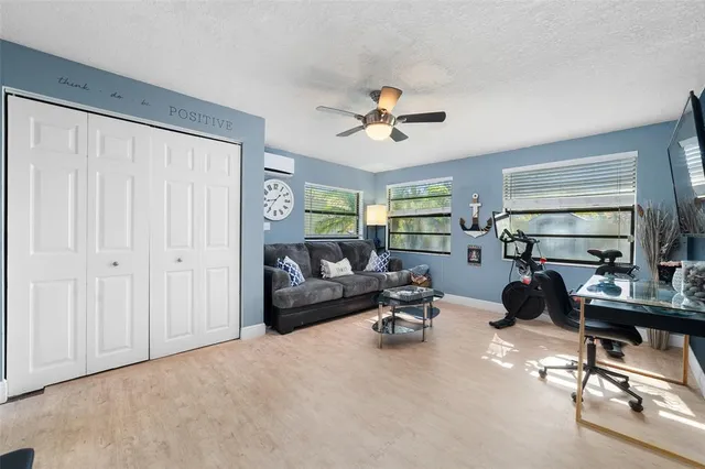 a living room with furniture gym equipment and a window