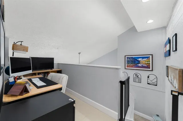 a view of a workspace with furniture and a gate