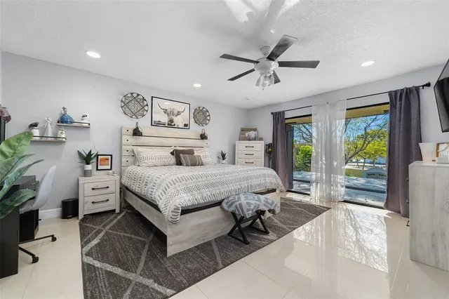 a bedroom with a bed and a large window