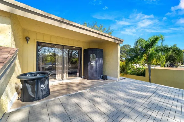 a view of a patio with table and chairs and potted plants