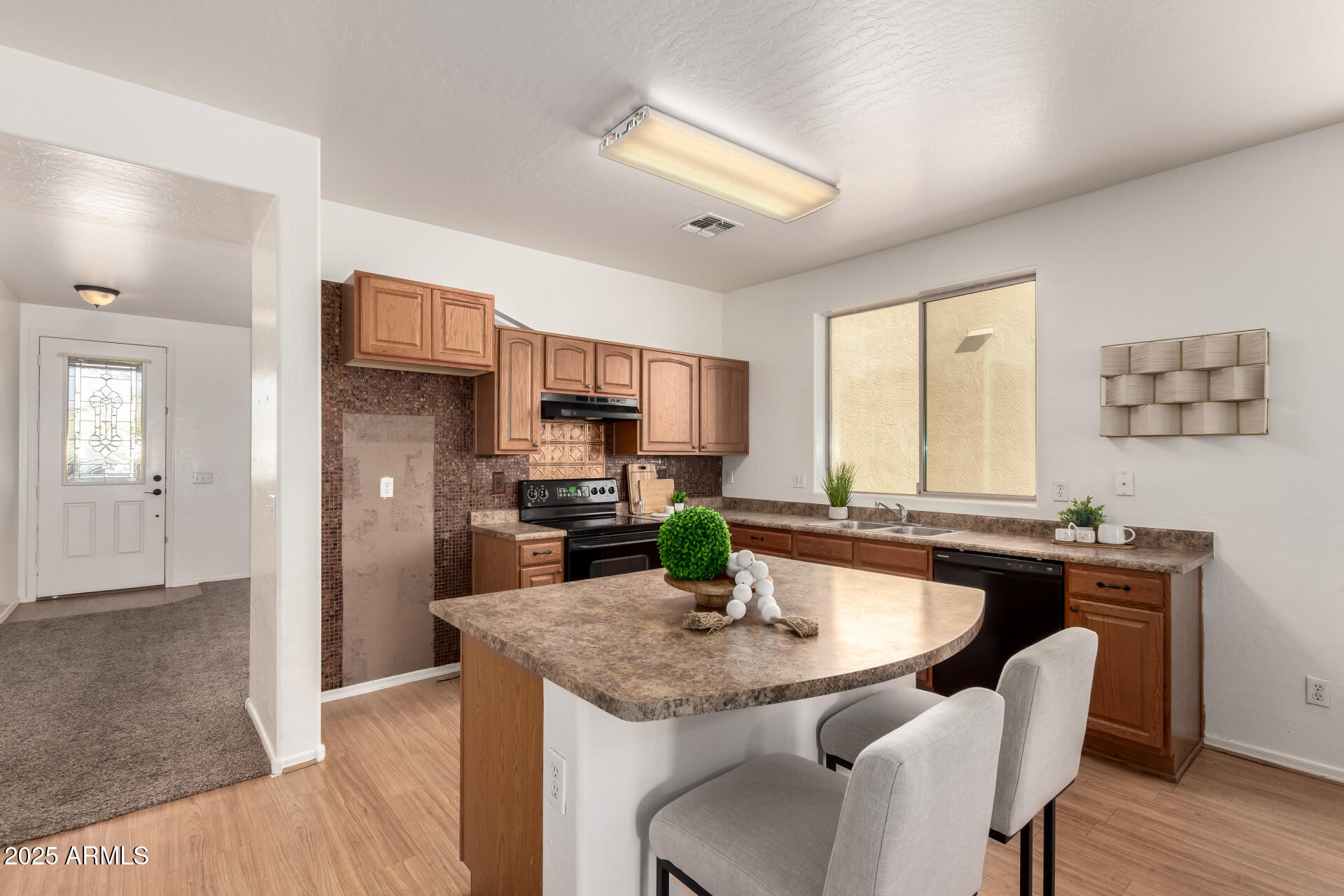 3129 West Fremont Rd. Phoenix, AZ 85041 - Photo 7 of 30 a kitchen with a table chairs refrigerator and microwave