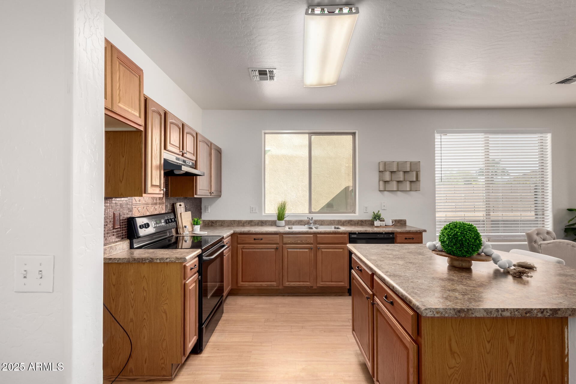 3129 West Fremont Rd. Phoenix, AZ 85041 - Photo 8 of 30 a kitchen with stainless steel appliances granite countertop a sink a stove and a refrigerator