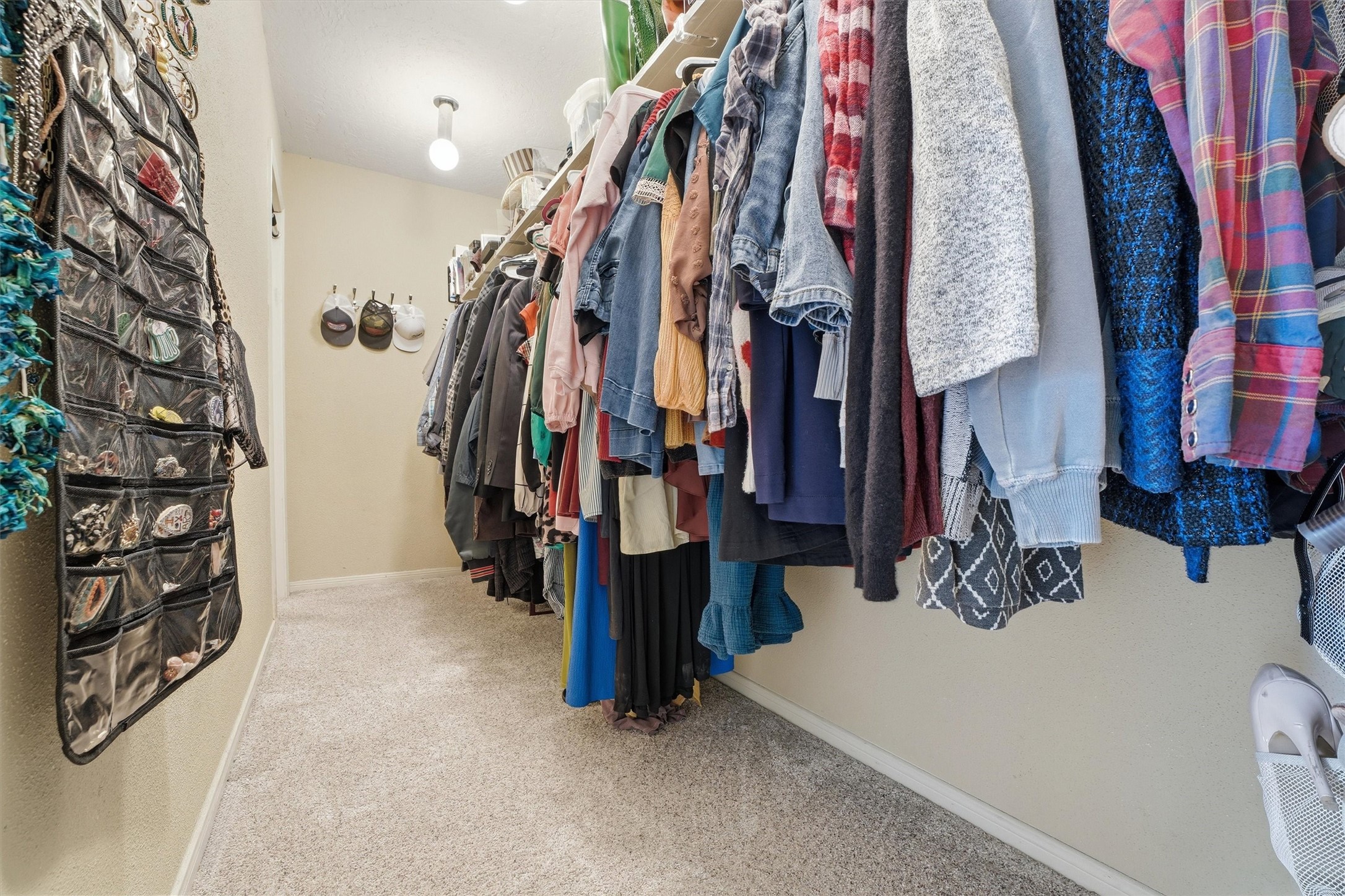 17663 Gardenia Lane New Caney, TX 77357 - Photo 11 of 37 a view of walk in closet with clothes and shoes