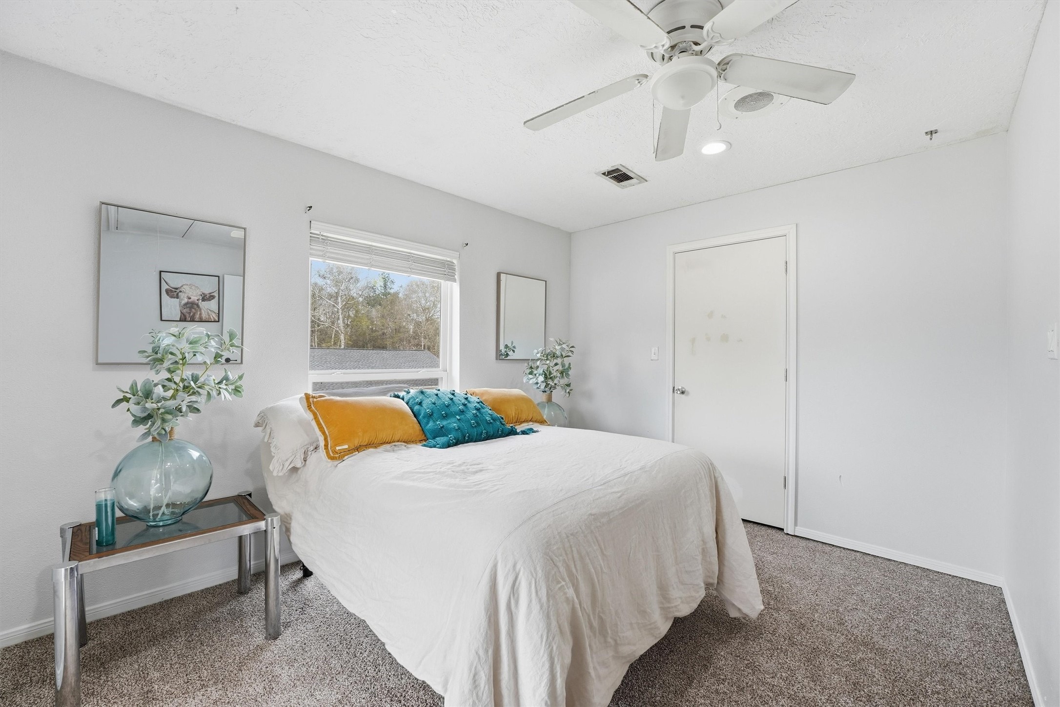 17663 Gardenia Lane New Caney, TX 77357 - Photo 12 of 37 a bedroom with a bed and a chandelier