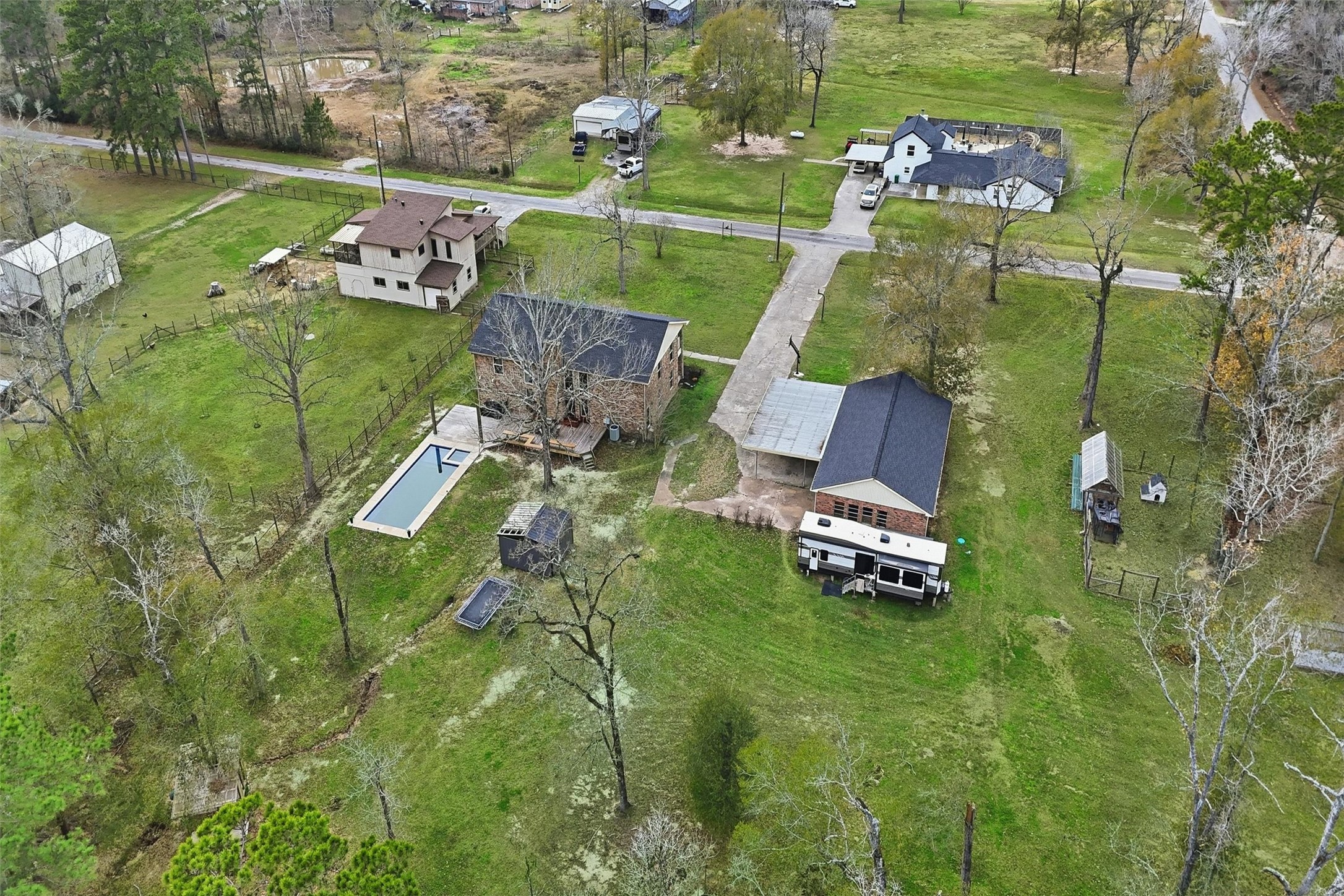 17663 Gardenia Lane New Caney, TX 77357 - Photo 30 of 37 an aerial view of a house with a garden and lake view