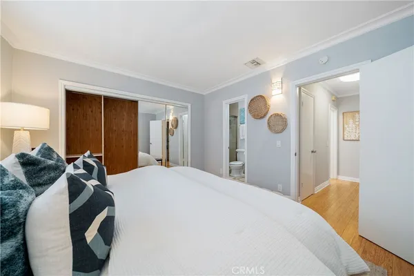 a bedroom with a bed and cabinets