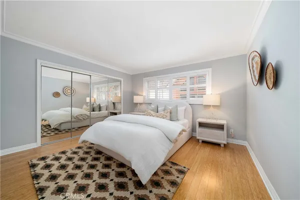 a bedroom with a bed and wooden floor