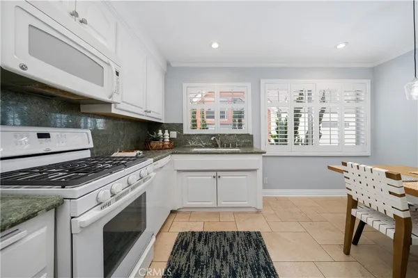a kitchen with a stove a sink and a microwave