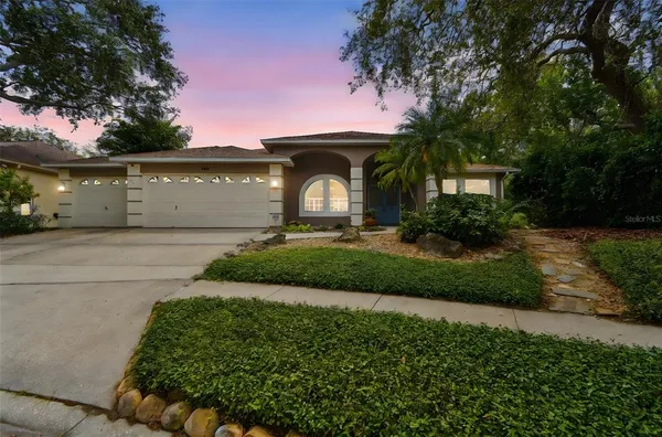 a front view of a house with a yard and a garage