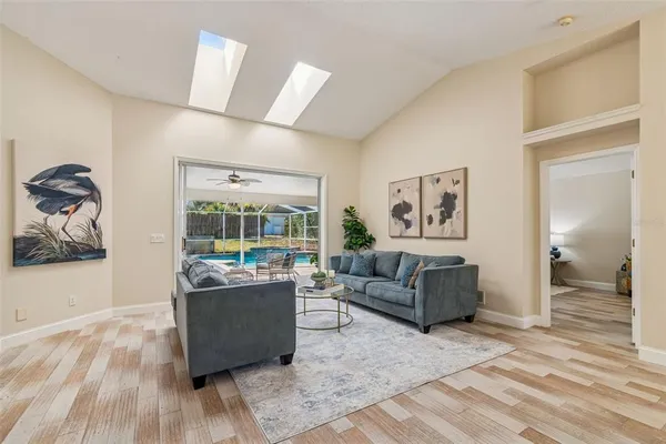 a view of a dining room with furniture a chandelier and wooden floor