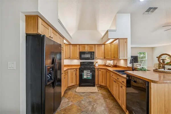 a view of a workspace with furniture and wooden floor