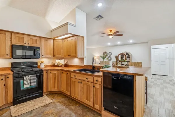 a bathroom with a granite countertop sink a toilet and shower