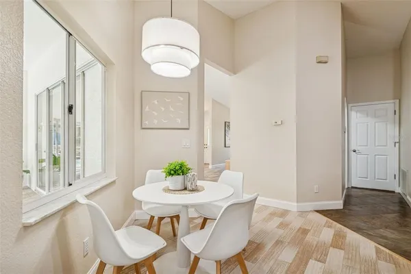 a view of a room with a ceiling fan and a window