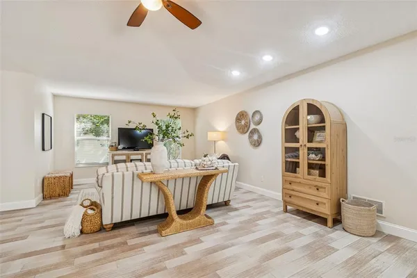 an empty room with a window and a ceiling fan