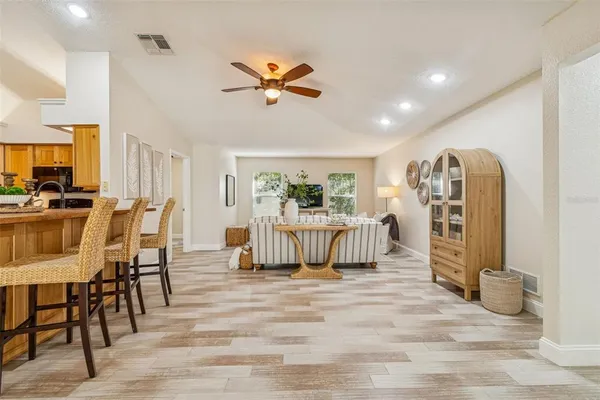 an empty room with a ceiling fan and wooden floor