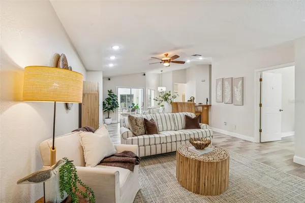 a living room with furniture and a potted plant