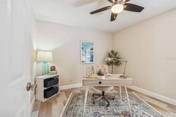 a living room with furniture a chandelier and a table