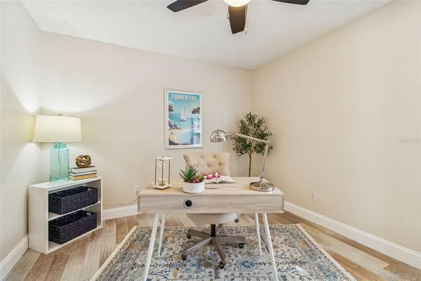 a view of a backyard with table and chairs under an umbrella