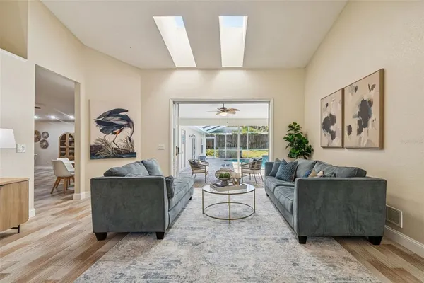 a dining room with furniture a window and wooden floor