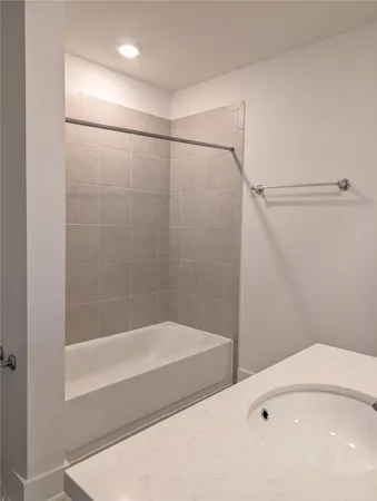 a bathroom with a shower and a bath tub