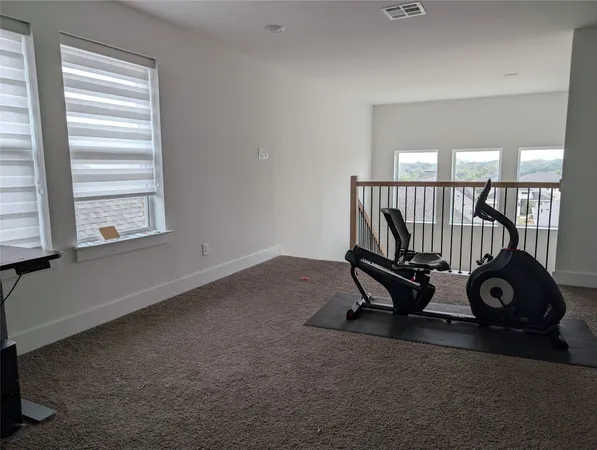 a room with gym equipment and windows