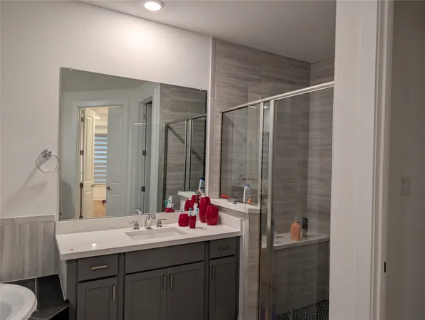 a bathroom with a sink vanity and a mirror