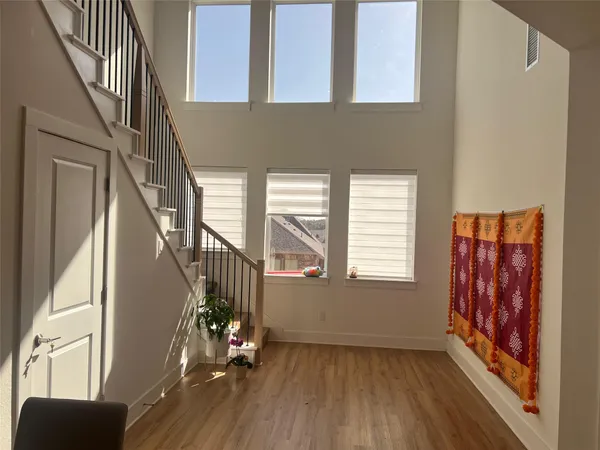 a view of an entryway with wooden floor and windows
