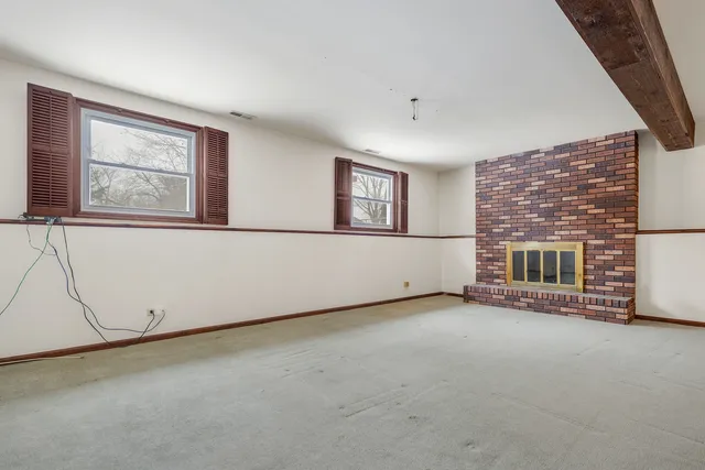 an empty room with a empty space and windows