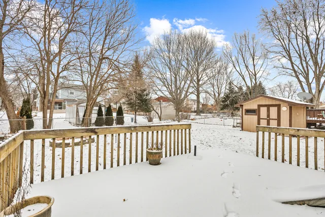 a view of a white house with a yard and covered with snow