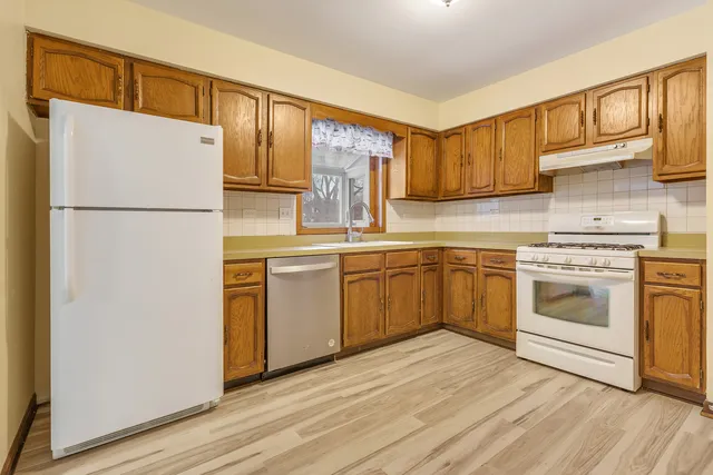 a kitchen with a white cabinets and white appliances