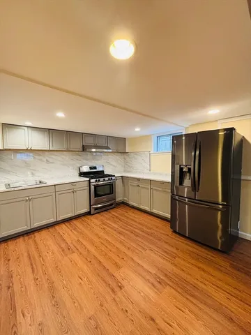 a kitchen with stainless steel appliances granite countertop a refrigerator and a sink