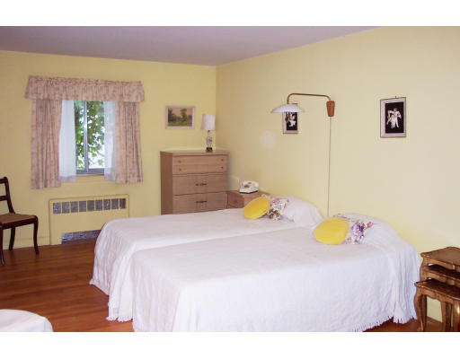 24 Longfellow Road Needham, MA 02494 - Photo 4 of 10 a bedroom with a bed and wooden floor