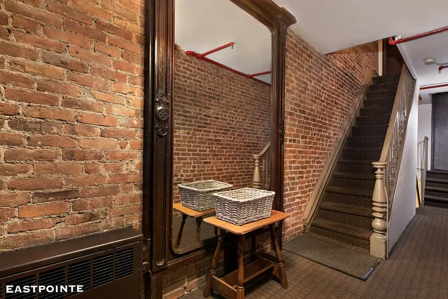 an aerial view of a house with a yard and large trees