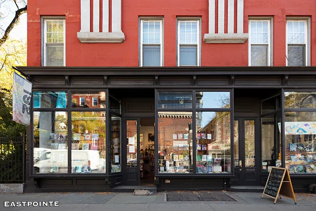 a view of a brick house with many windows