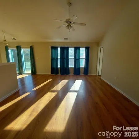 a view of a room with wooden floor