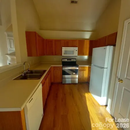 a kitchen with a sink appliances and cabinets