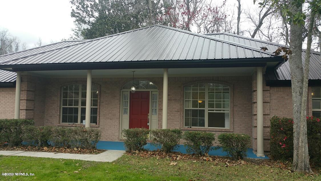 a view of a house with a yard and plants