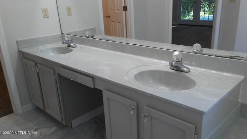1780 Denmark Drive Fleming Island, FL 32003 - Photo 18 of 25 a bathroom with double sink and a mirror