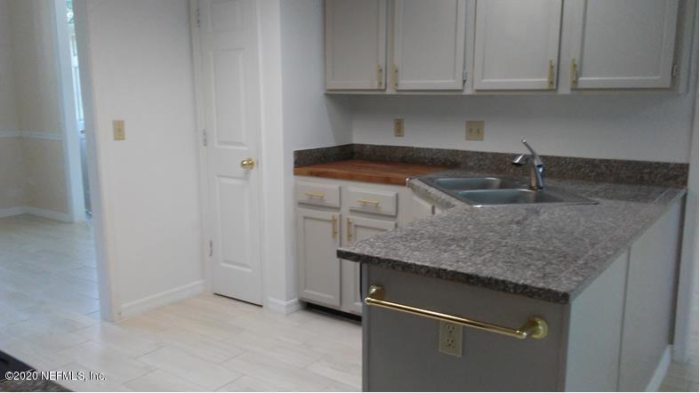 1780 Denmark Drive Fleming Island, FL 32003 - Photo 9 of 25 a kitchen with granite countertop white cabinets and a sink