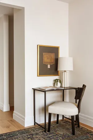 a bedroom with a bed and a large mirror next to a window