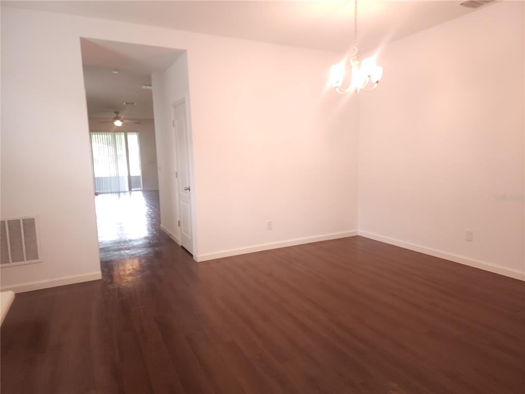 3230 Stratton Circle Kissimmee, FL 34744 - Photo 5 of 28 a view of an empty room with wooden floor and a window