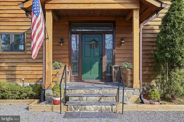 a living room with furniture a wooden floor and a large window