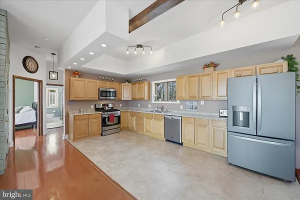 a spacious bedroom with a large bed and a wooden floor