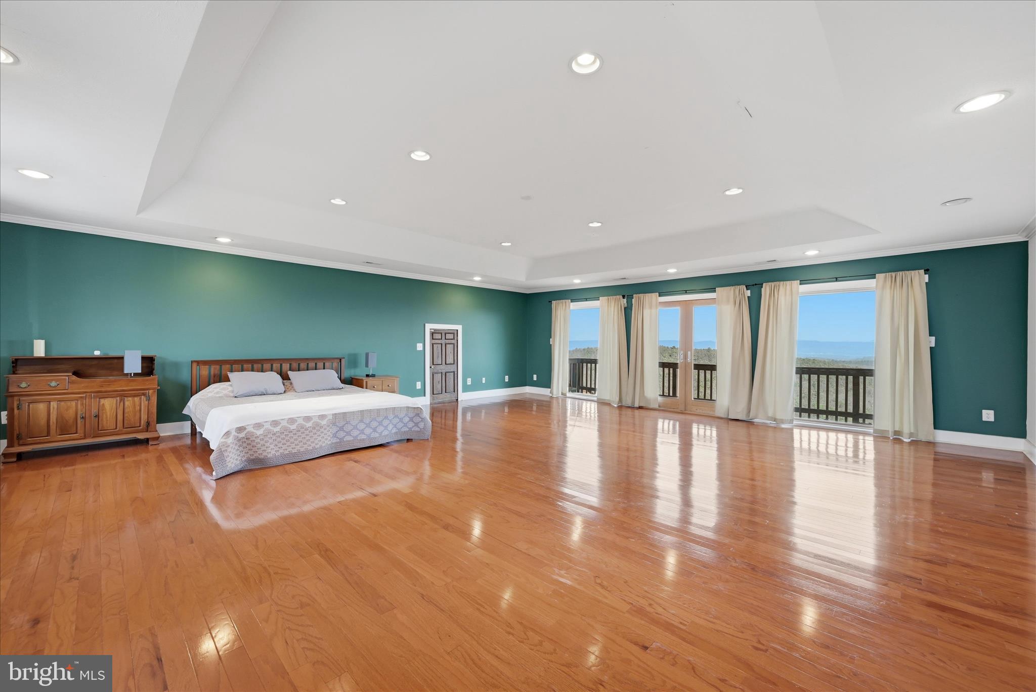 2152 Supinlick Ridge Road Broadway, VA 22815 - Photo 33 of 89 a spacious bedroom with a large bed and a wooden floor