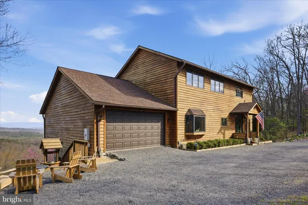 a living room with furniture a flat screen tv and a floor to ceiling window