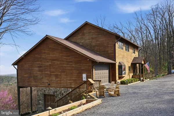 a living room with fireplace furniture and a large window