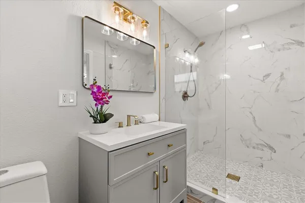a bathroom with a sink vanity and a mirror
